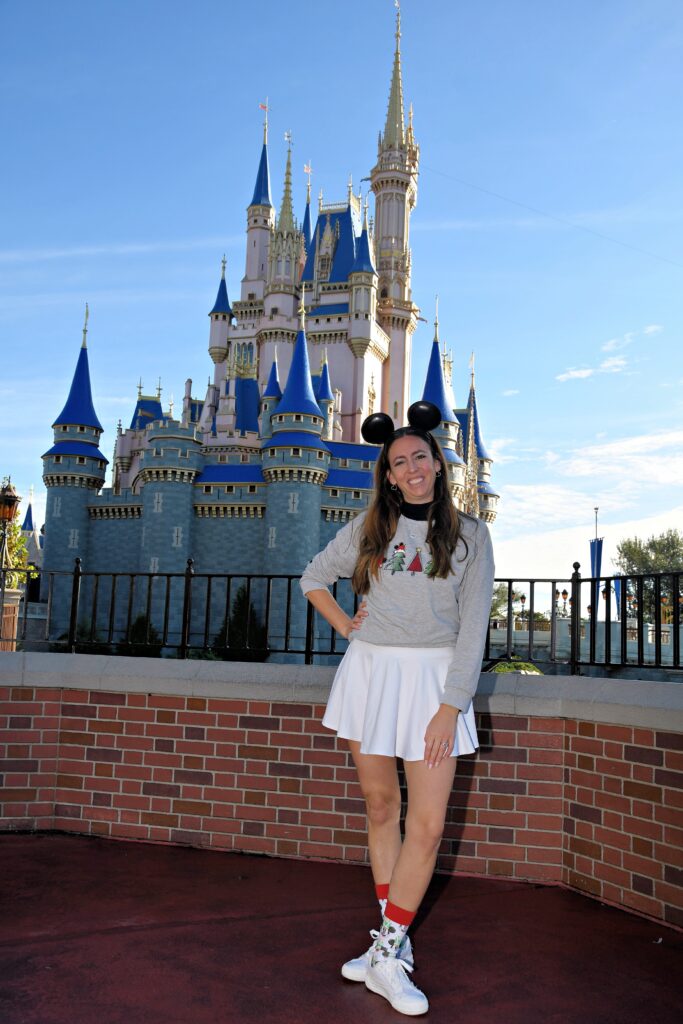 owner of wishes planning services in front of Disney castle.
